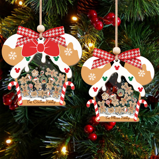 Two Christmas ornaments with gingerbread men and candy canes on a decorated tree.